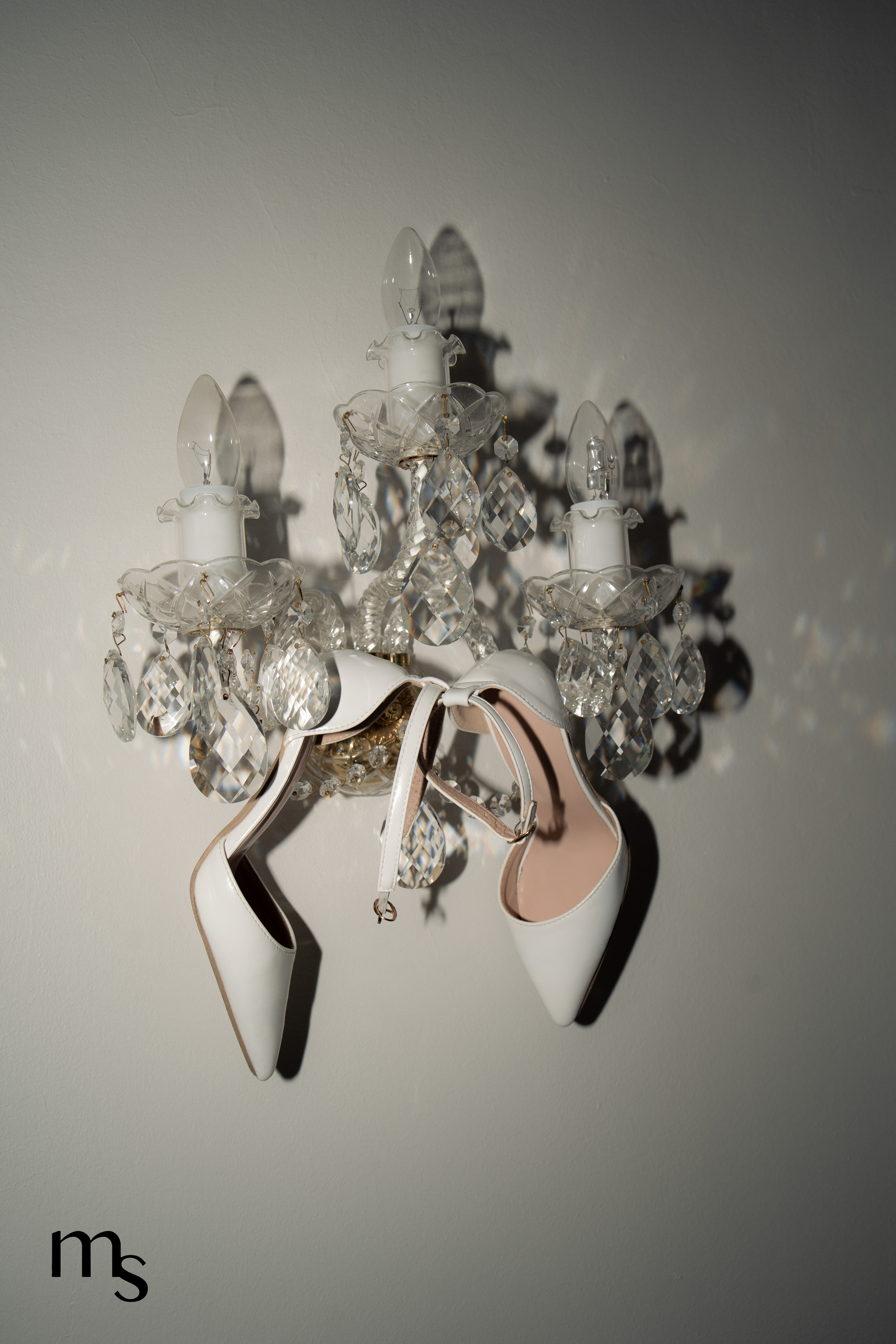 Escarpins de la mariée accrochée à un lustre au chateau de la Beaumetane en Provence